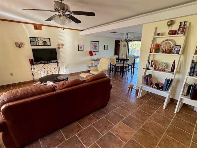 living room featuring crown molding and ceiling fan with notable chandelier