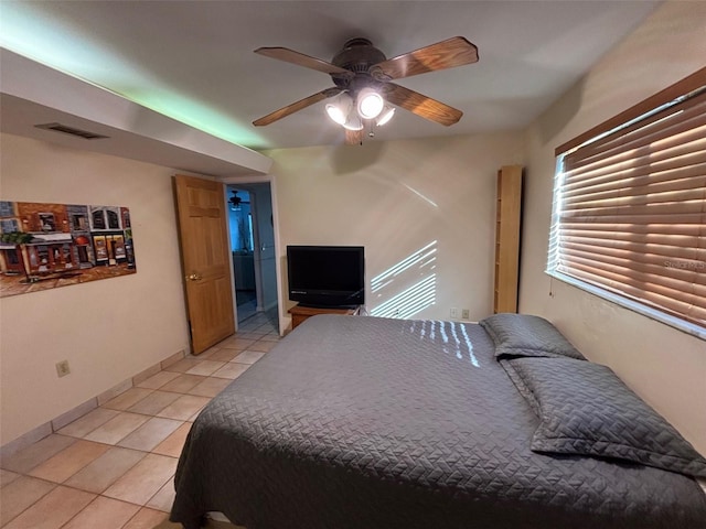 tiled bedroom with ceiling fan