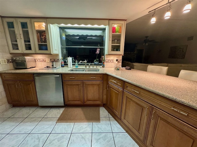 kitchen with ceiling fan, pendant lighting, stainless steel dishwasher, sink, and light tile patterned floors