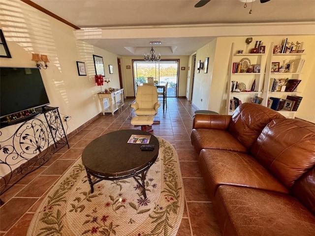 tiled living room with ceiling fan with notable chandelier