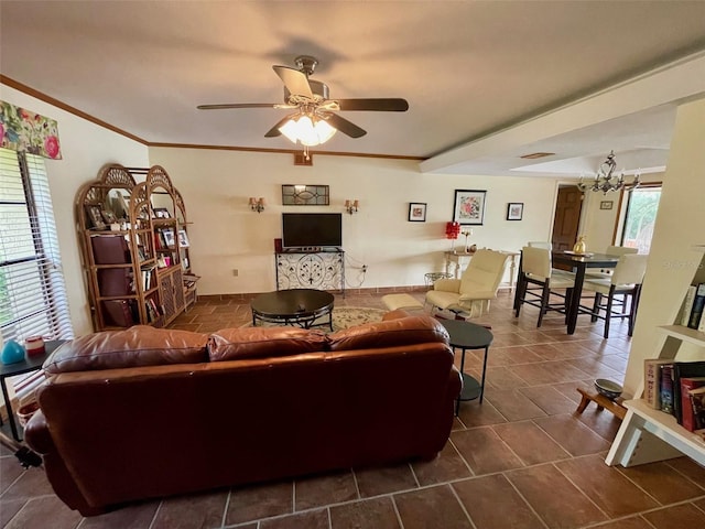 living room featuring crown molding and ceiling fan with notable chandelier