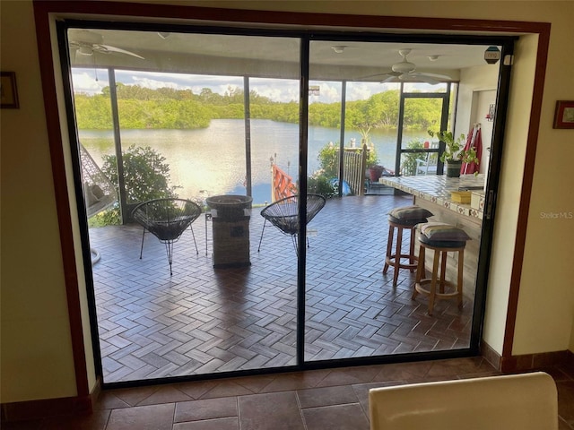 entryway featuring a water view and tile patterned floors