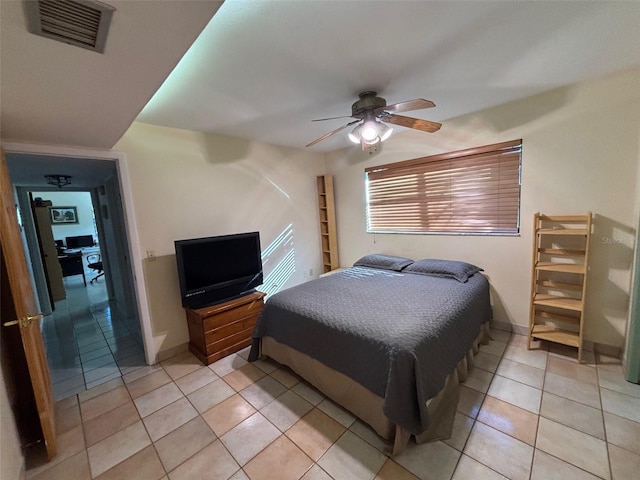 bedroom with ceiling fan and light tile patterned floors