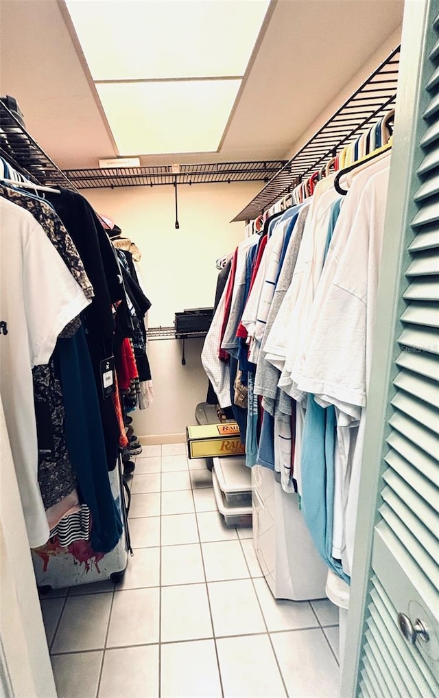 spacious closet with light tile patterned floors