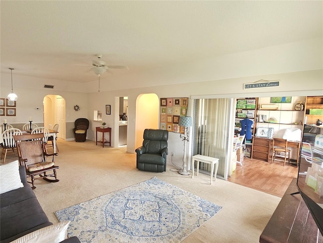 carpeted living room featuring ceiling fan