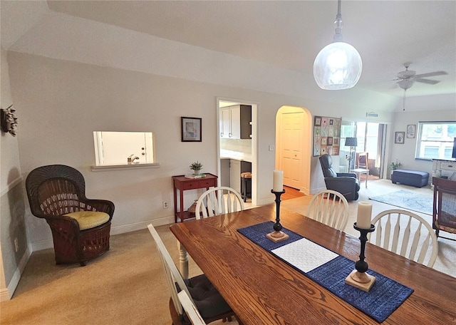 carpeted dining room featuring ceiling fan