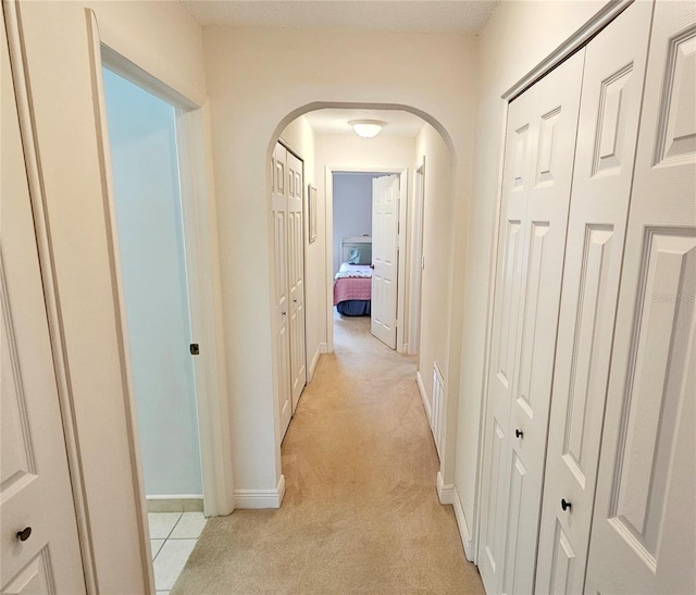 corridor with light colored carpet