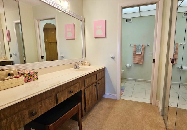 bathroom with vanity, tile patterned floors, and toilet