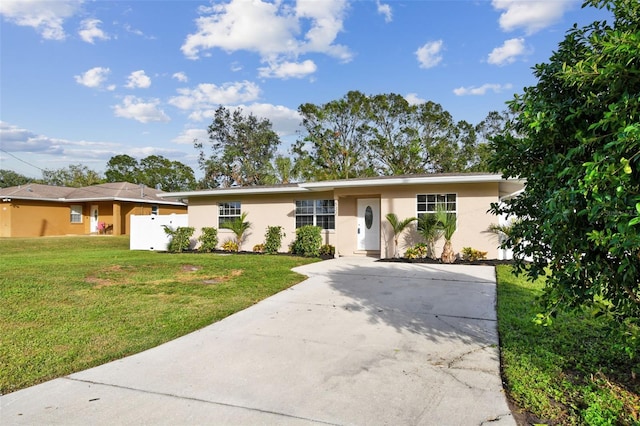 single story home with a front lawn