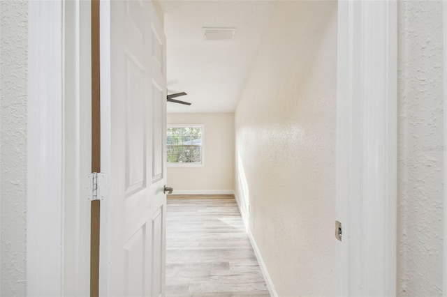 831 Searcy Ave, Sarasota, FL 34237 - corridor featuring light wood finished floors and a textured wall
