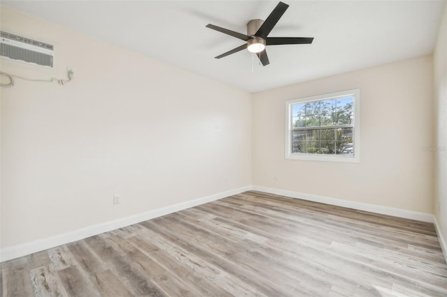 831 Searcy Ave, Sarasota, FL 34237 - spare room with wood finished floors, ceiling fan, and an AC wall unit