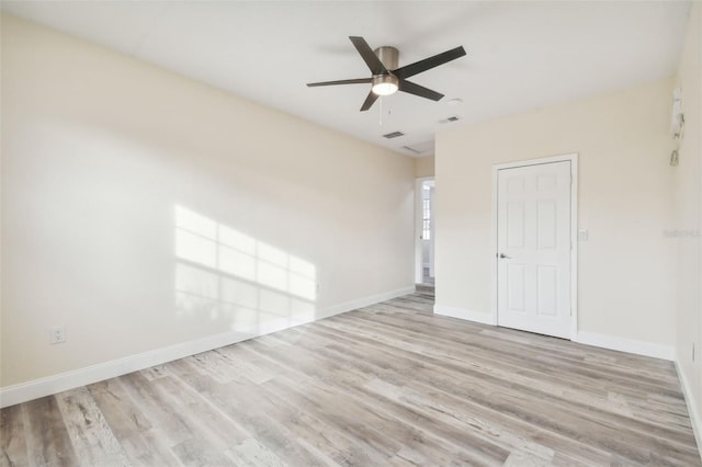 spare room with ceiling fan and light wood-type flooring