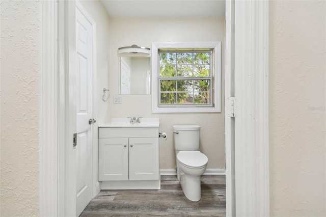 831 Searcy Ave, Sarasota, FL 34237 - bathroom featuring vanity, wood finished floors, and a textured wall