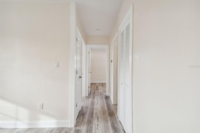 hallway with light hardwood / wood-style flooring