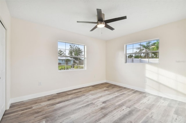 interior space featuring light wood-type flooring, ceiling fan, and a healthy amount of sunlight