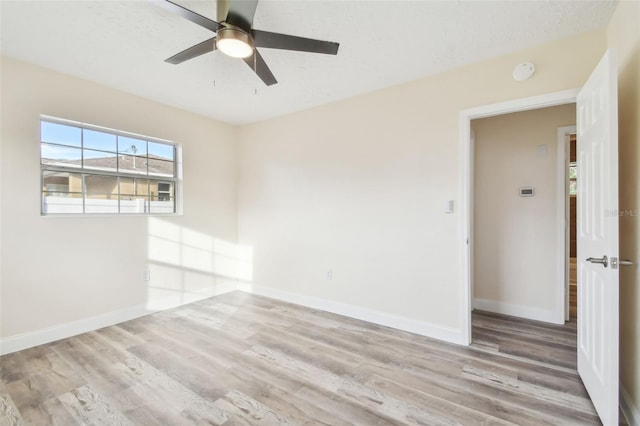 unfurnished room featuring ceiling fan, light hardwood / wood-style floors, and a textured ceiling