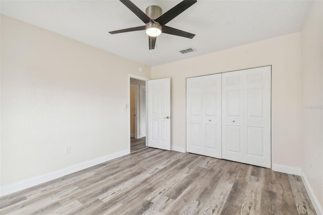 831 Searcy Ave, Sarasota, FL 34237 - unfurnished bedroom with wood finished floors, a closet, and ceiling fan