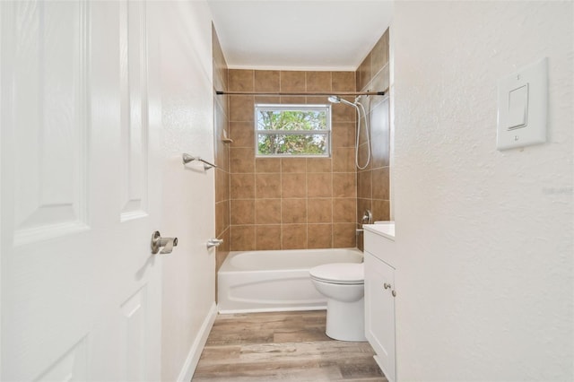 full bathroom with vanity, toilet, wood-type flooring, and tiled shower / bath combo