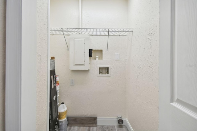 831 Searcy Ave, Sarasota, FL 34237 - washroom featuring electric panel, wood finished floors, a textured wall, and washer hookup