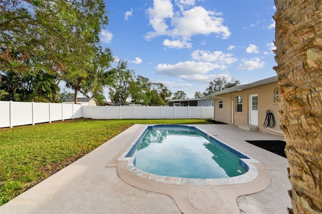 view of swimming pool with a lawn and a patio area