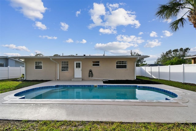 back of property featuring a fenced in pool