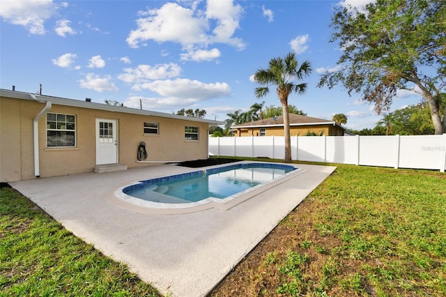 view of pool featuring a lawn