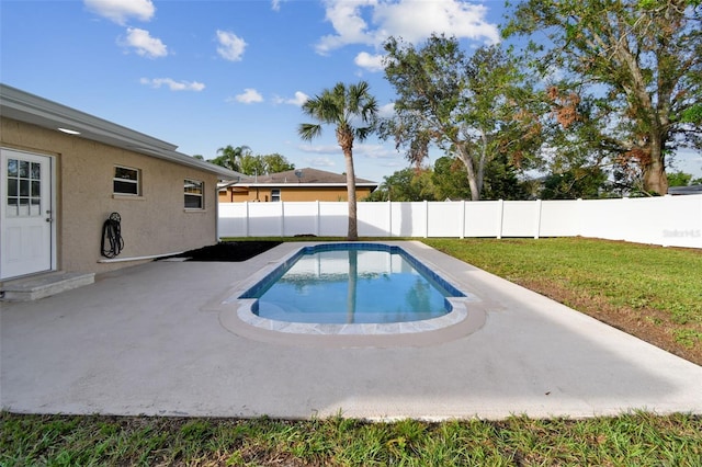 view of pool with a lawn and a patio