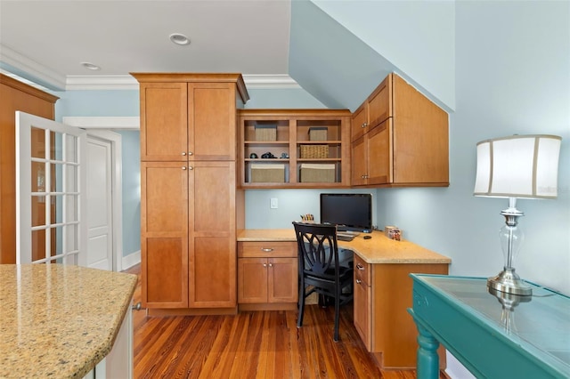 office area with built in desk, dark hardwood / wood-style flooring, and ornamental molding