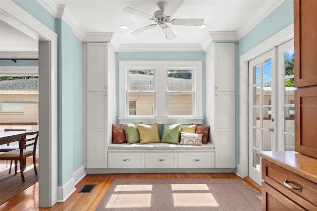 interior space with ceiling fan, ornamental molding, and light hardwood / wood-style floors