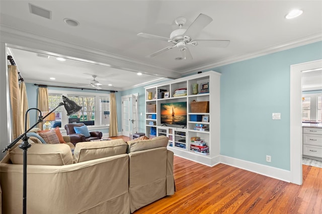 living room featuring ceiling fan, crown molding, and light hardwood / wood-style floors