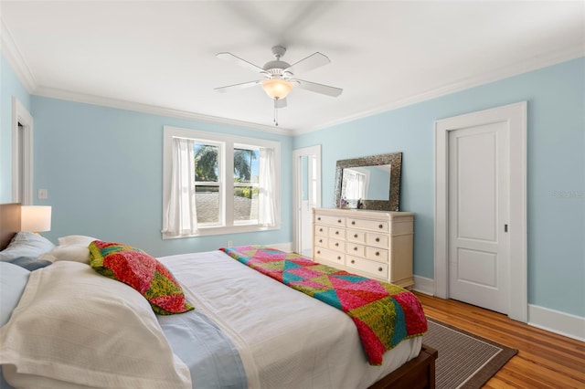 bedroom featuring ceiling fan, crown molding, and hardwood / wood-style floors