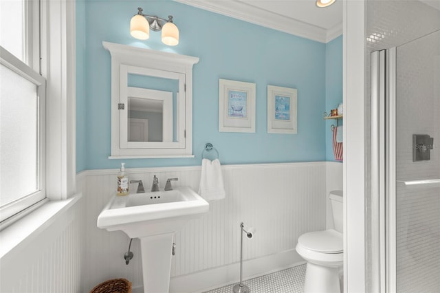 bathroom with toilet, tile patterned flooring, walk in shower, and crown molding