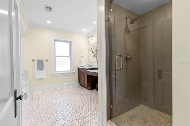 bathroom featuring tile patterned floors, crown molding, a shower with shower door, and vanity