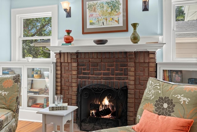 room details featuring a brick fireplace and wood finished floors