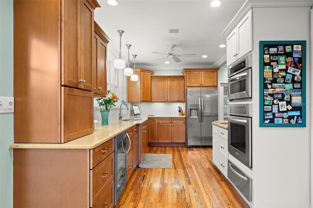 kitchen with light countertops, brown cabinets, a sink, and stainless steel fridge with ice dispenser