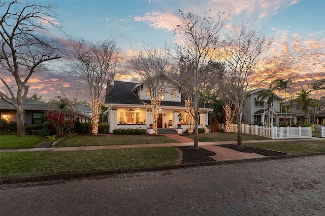 view of front facade with a front yard and fence