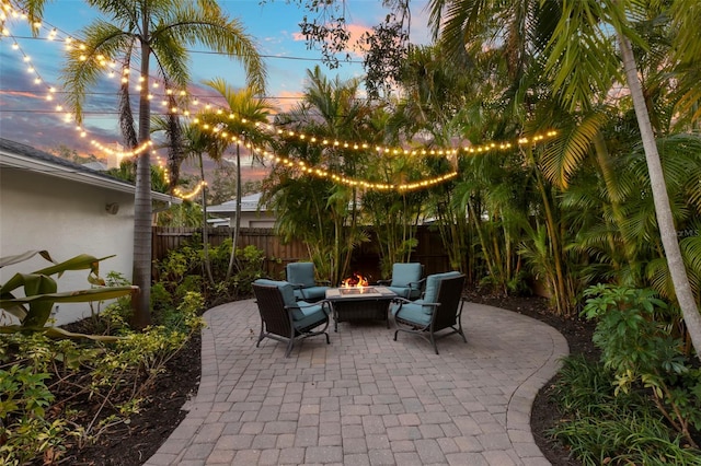 view of patio with an outdoor fire pit and a fenced backyard