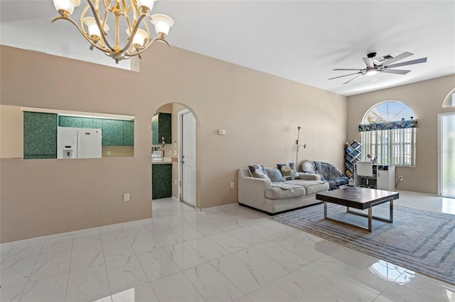 living room featuring ceiling fan with notable chandelier and light tile patterned floors