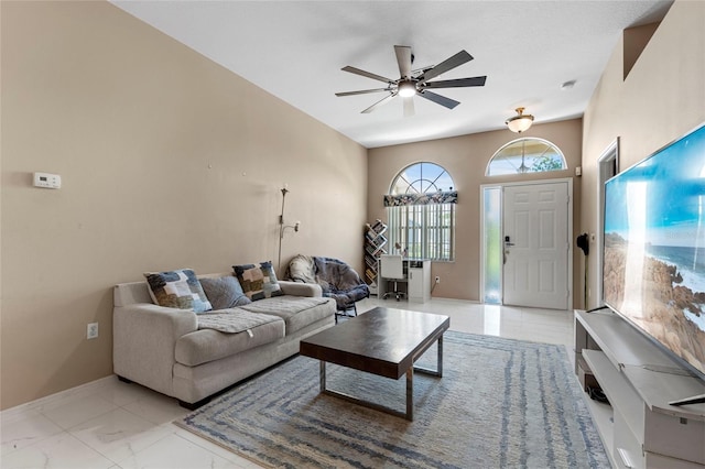 tiled living room with ceiling fan