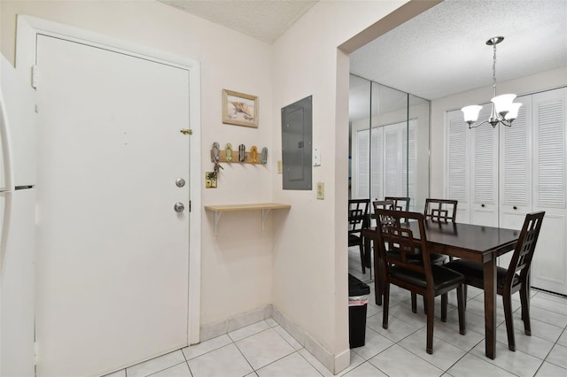 tiled dining room with electric panel, a textured ceiling, and a notable chandelier