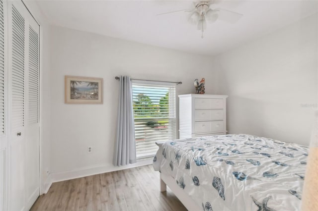 bedroom with ceiling fan, a closet, and light hardwood / wood-style flooring