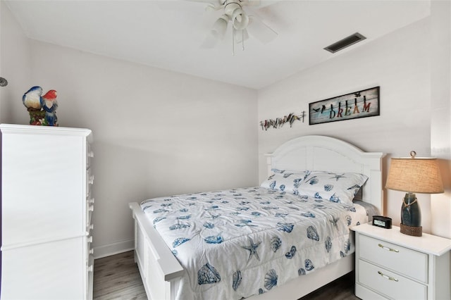 bedroom with ceiling fan and dark hardwood / wood-style flooring