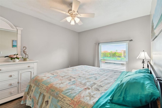 bedroom with ceiling fan and dark hardwood / wood-style flooring