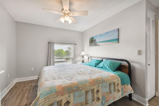 bedroom with ceiling fan and dark hardwood / wood-style flooring