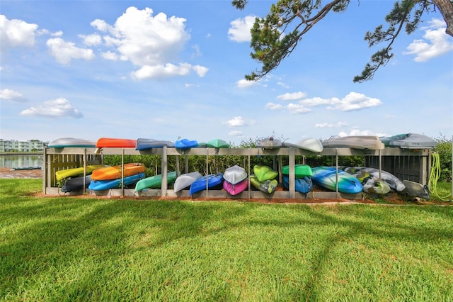 view of play area featuring a water view and a yard