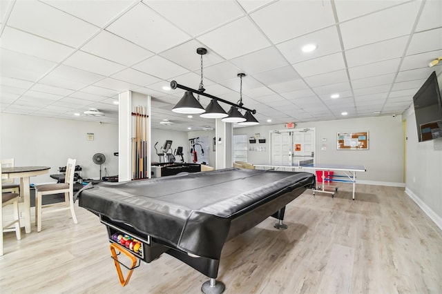 recreation room with a drop ceiling, pool table, and light wood-type flooring