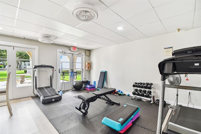 workout area with a drop ceiling and french doors