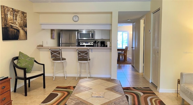 kitchen featuring appliances with stainless steel finishes and light tile patterned flooring