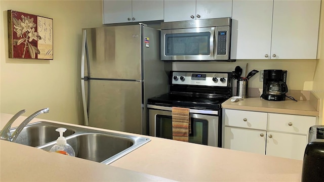 kitchen featuring sink, white cabinetry, and appliances with stainless steel finishes