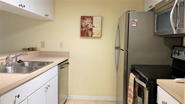 kitchen featuring sink, light tile patterned flooring, white cabinets, and stainless steel appliances